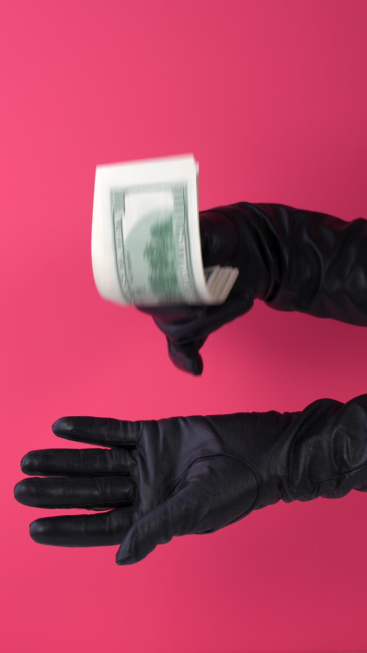 Gloved Hands Transferring Stack of US Dollar Bills