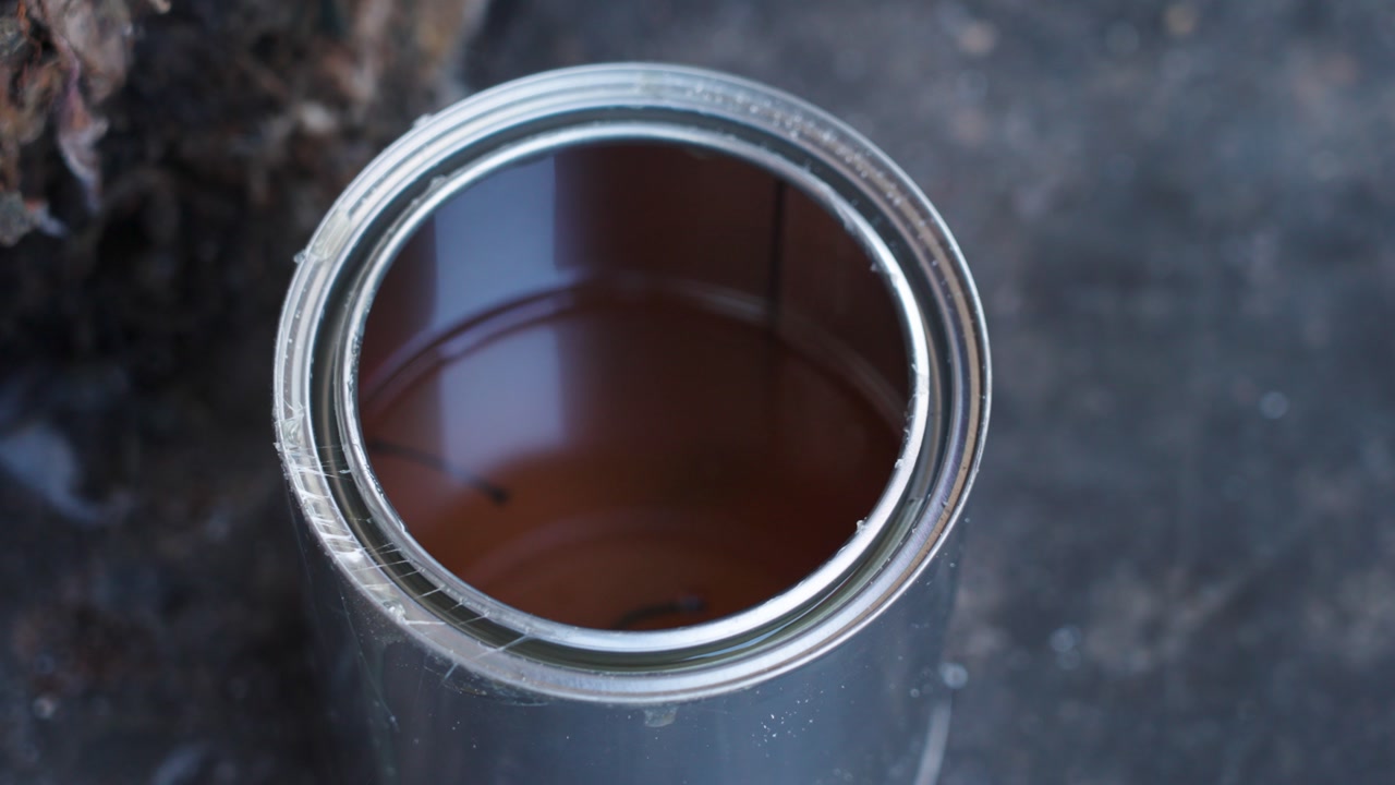 Close-up of glue for shoe repair in Malaysia. Slow-motion showing a can of glue of a cobbler with skilled hands, craftsmanship, and everyday street service work.