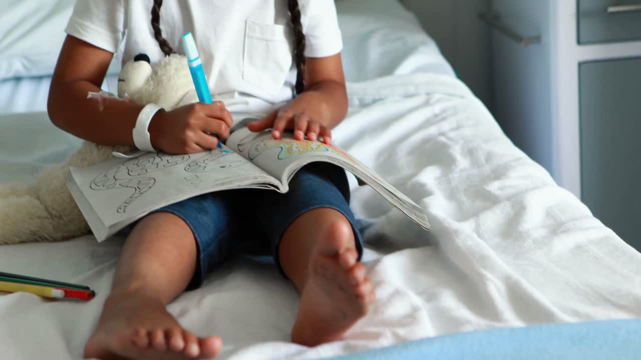 Girl drawing picture in a book