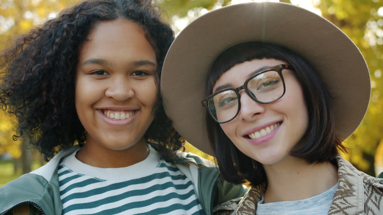 dos amigos disfrutando del otoño en un parque