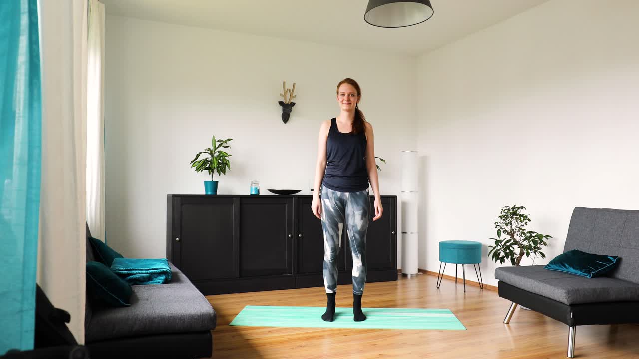 young girl doing her workout at home in the living room