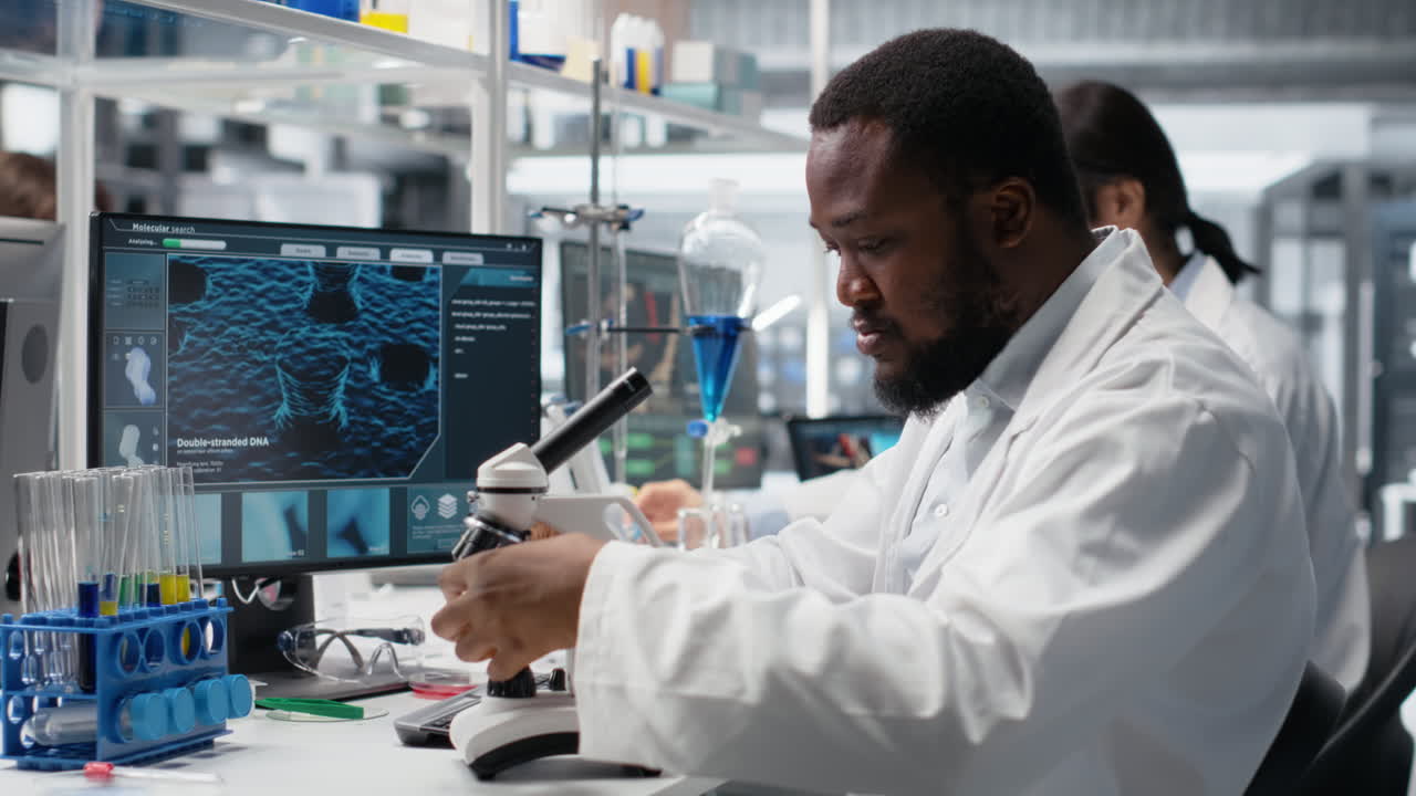 Vertical video Chemical engineer using microscope to evaluate test specimens in lab