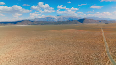 deserted dry landscape with no vegetation. breath-taking scenery of mountains at the backdrop of blue sky with soft clouds at backdrop.