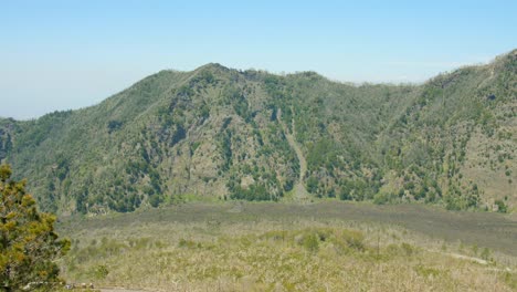 Panning-across-the-green-surroundings,-mountains-and-cliffs-of-the-Mount-Vesuvius-volcano-near-Pompeii-and-Herculanum,-Italy