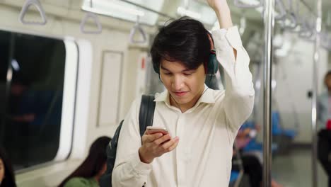 businessman using mobile phone on public train