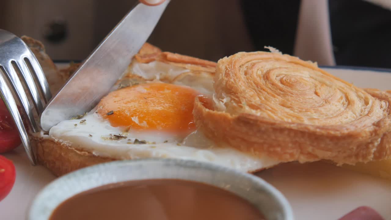 Fried egg with croissant and tomatoes