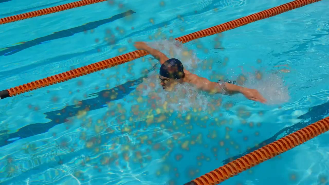 Male swimmer starting stroke cycle after arm reach in lane, golden spots following, sports training