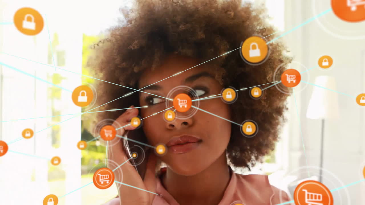 Animation of network of connected icons in circles over african american woman using smartphone