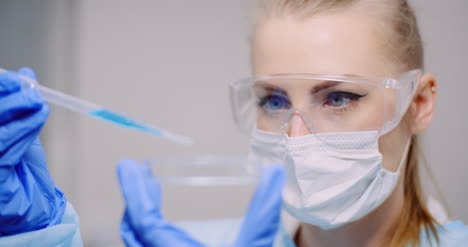 doctor carefully drips medicine from pipette into sample glass tubes for dna analysis at laboratory 3