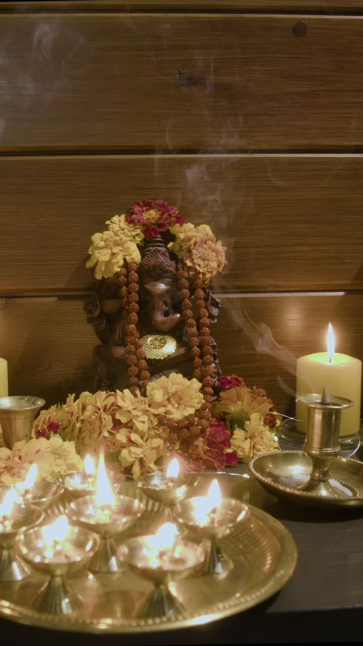 Ganesha Statue with Candles and Flowers