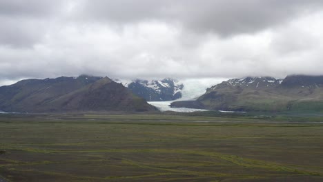 Iceland-glacier-wide-shot-with-clouds-and-drone-video-moving-up