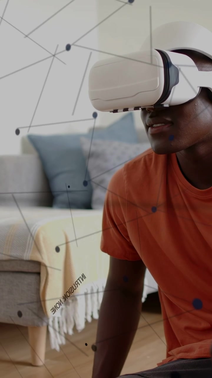 Vertical video: Man sitting on floor with VR headset tilting head making nodes expand for tech demo
