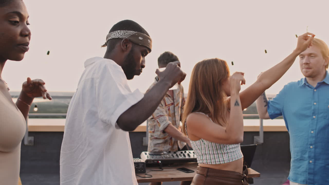 Happy Young People Dancing at Rooftop Party