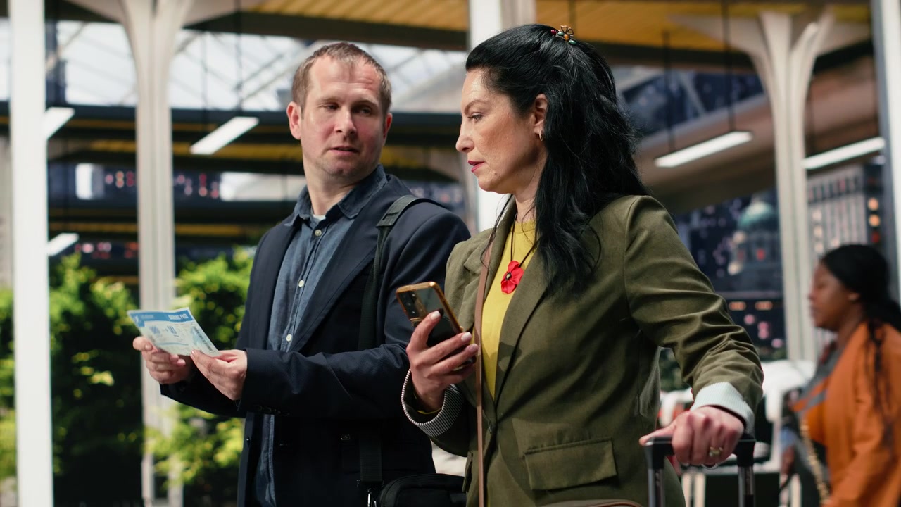Business travelers compare printed bus ticket with smartphone information