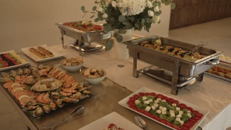 Elegant buffet table with assorted dishes and floral centerpiece for an event
