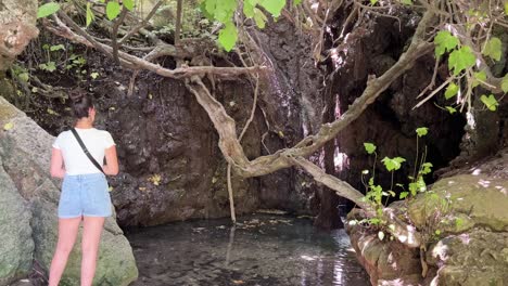 Beautiful-women-looking-at-the-Baths-of-Aphrodite-in-Paphos,-Cyprus-4K