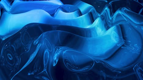 looped abstract liquid background with wavy sparkling pattern on shiny glossy surface. viscous blue fluid like surface of foil or brilliant glass. beautiful creative festive backdrop. simple bright bg