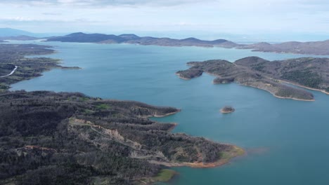 Slow-cinematic-aerial-pan-shot-of-lake-Plastira-in-central-Greece-during-a-spring-afternoon-|-4K