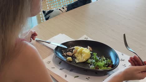 woman eating lunch at a restaurant