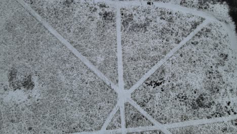 huellas en la nieve caminos abstractos en el campo cruzando el aumento del dron