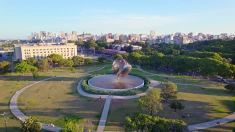 aerial view establishing the floralis generica and the united nations park in the recoleta neighborhood, residential buildings in the background