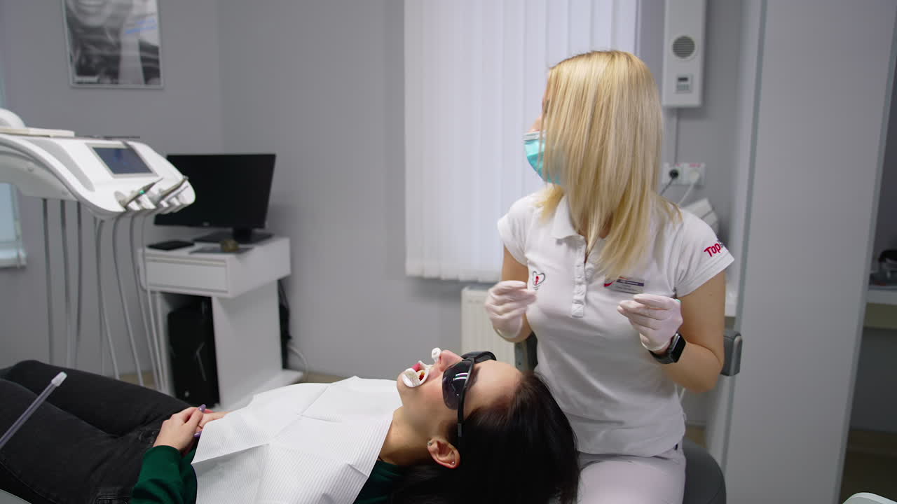 Woman dentist working with patient. Dentist examining patient teeth in the dental clinic