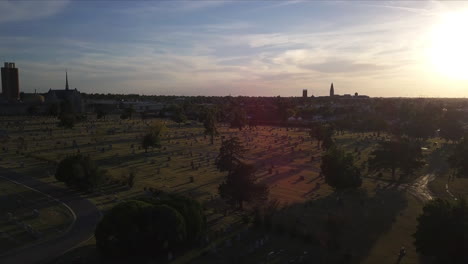 Aerial panoramic view of cemetery in the morning featuring scattered graves in war memorial forward motion drone