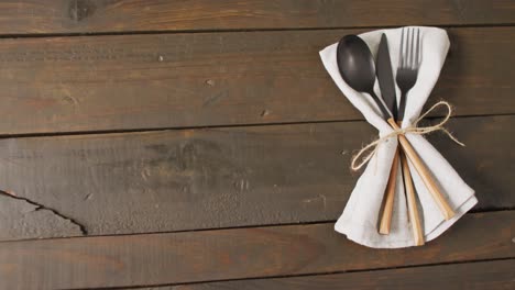 video of cutlery and cloth lying on wooden surface