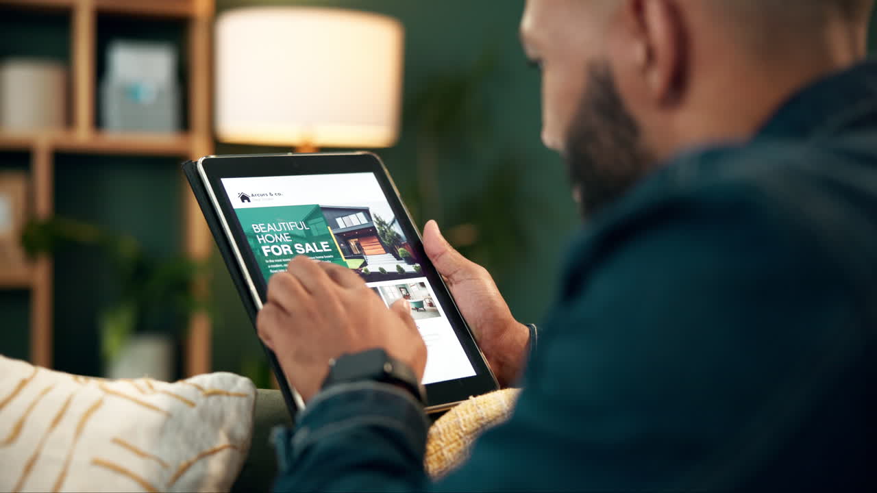 Man Browsing Real Estate Listings on Tablet