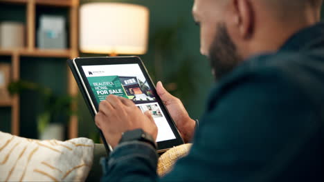 man browsing real estate listings on tablet