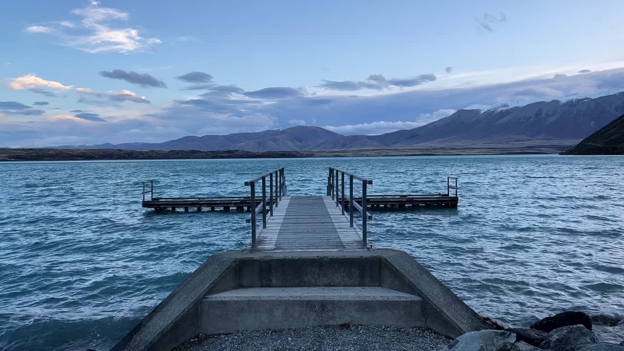Jetty at blue lake in mountains of New Zealand's south island