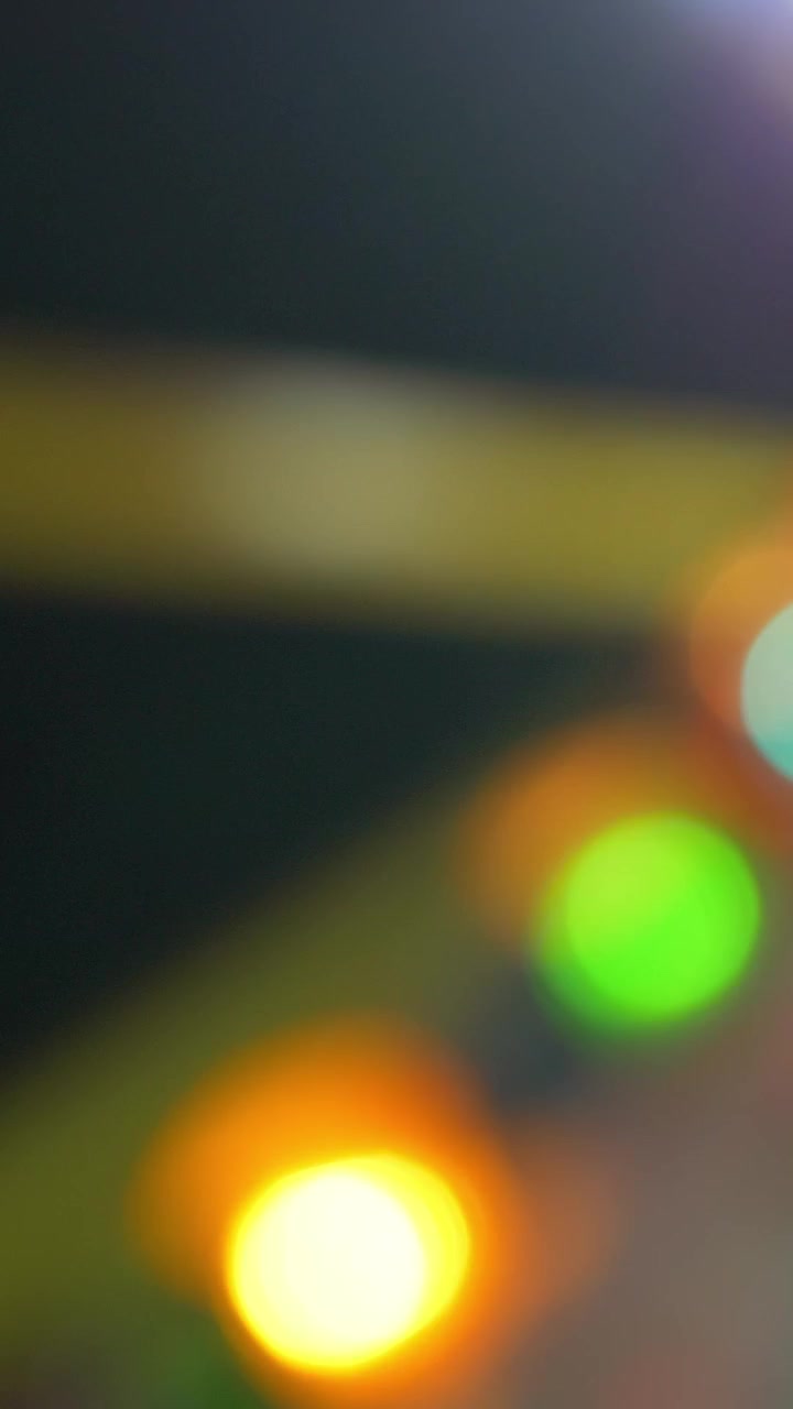 Colorful illumination of attraction at fun fair, defocus