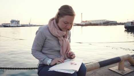 woman drawing at the port