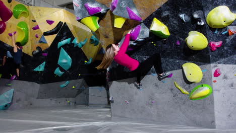 teenage girl bouldering indoors