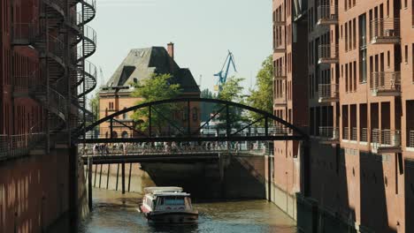 Speicherstadt-Hamburg-with-barkasse--passing-through-the-canal