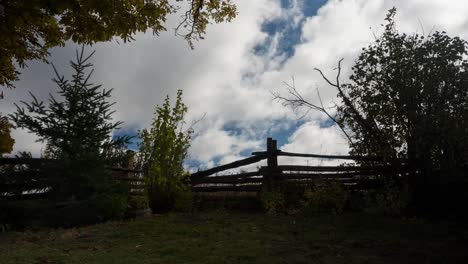 dramatic clouds moving over a rural fence, landscape timelapse