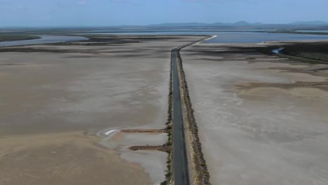 Rectilinear-deserted-road-across-wild-flat-territory-of-Casuarina-island-in-Queensland,-Australia