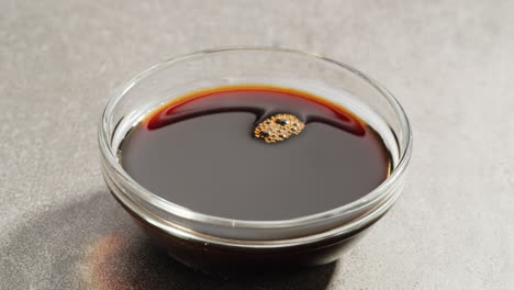 dipping a dumpling in soy sauce