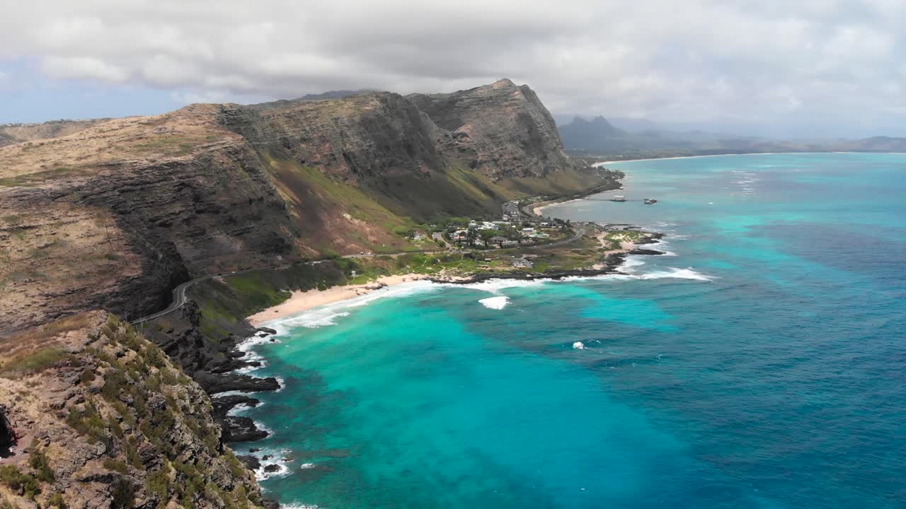 Version One. Aerial Shot over Makapu'u Beach and Makapu'u Lookout with Beautiful Ocean, Clouds and Cliffs in Oahu, Hawaii