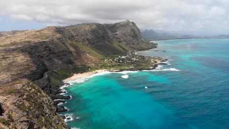 version one. aerial shot over makapu'u beach and makapu'u lookout with beautiful ocean, clouds and cliffs in oahu, hawaii