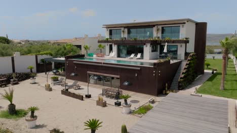 aerial establishing shot of an expensive seafront villa in frontignan, frace