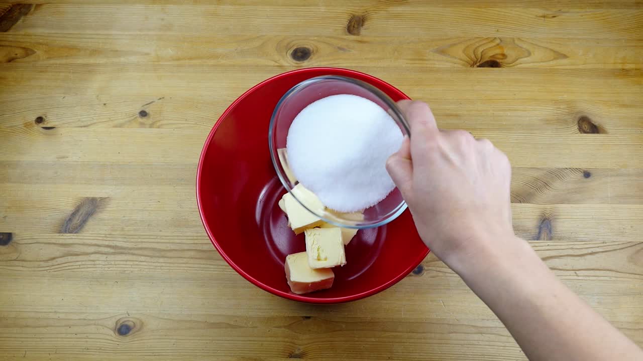 putting butter and suger into a bowl for making a dough