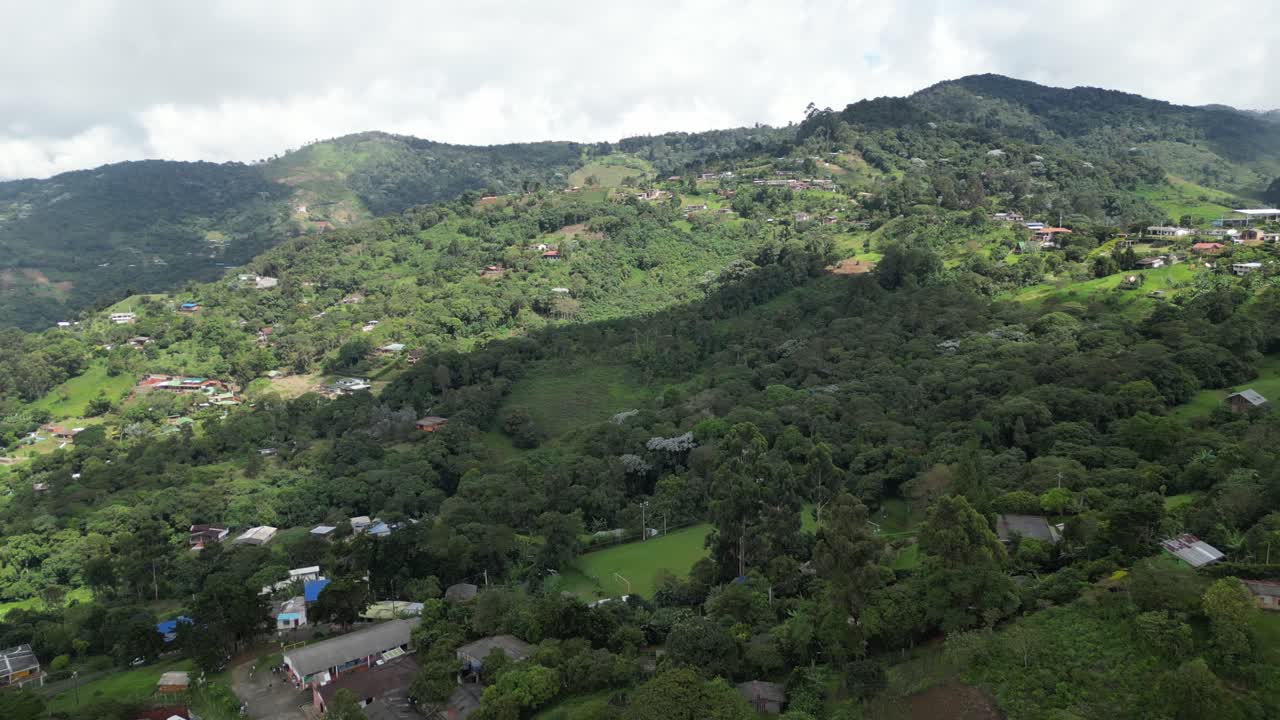 Aerial view of the lush hills around La Paz near Cali in the Valle del Cauca Department of Colombia, showing rural landscapes on a cloudy day