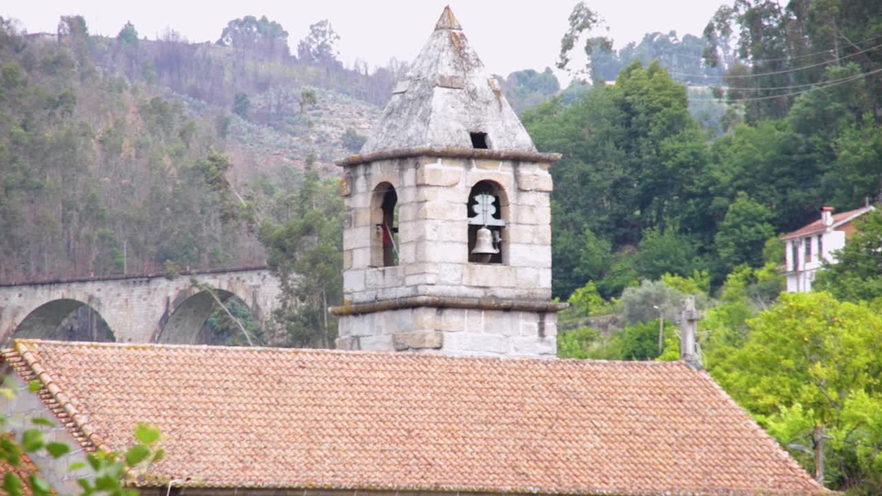Up close, the bell at church of S&atilde;o Tiago de Valadares in Bai&atilde;o stands prominent