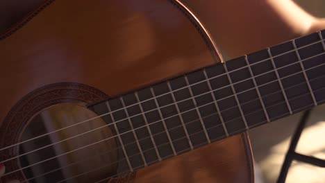 4K-Young-female-kindly-playing-guitar-outdoors-daylight-closeup