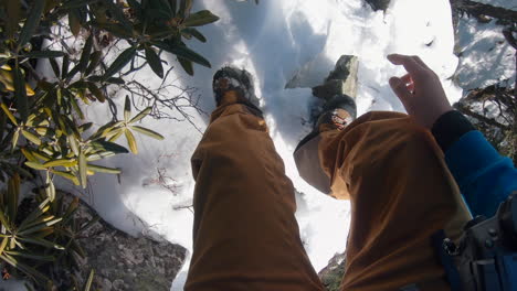 a-man-climbing-a-steep-mountain-rock-by-hand