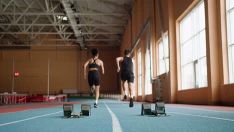 back view of athletes running