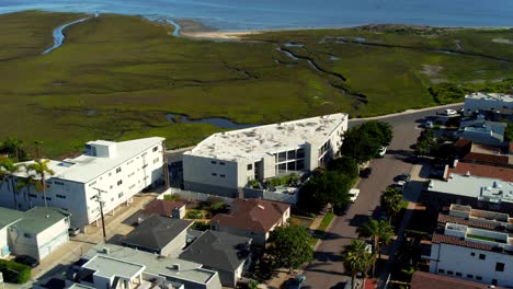 Drone-shot-of-Bayfront-Apartment-Complex-in-front-of-Mission-Bay,-in-San-Diego,-California