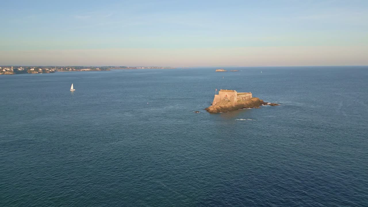 Distanced drone view of the French historical Petit Bé island in sunset, Saint-Malo, Bretagne, France.