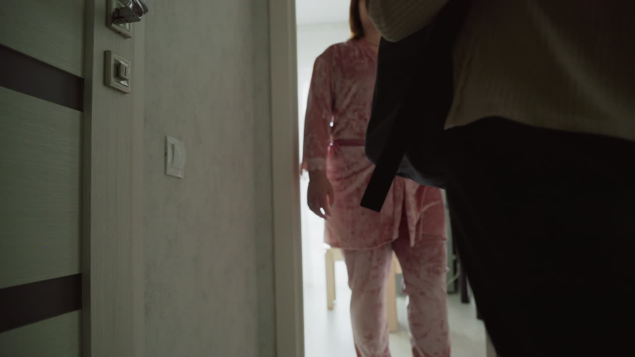 girl and boy wearing casual clothes with backpacks walking through hallway after packing books for school, smiling confidently, prepared for day, bright natural light from window highlights cheerful energy